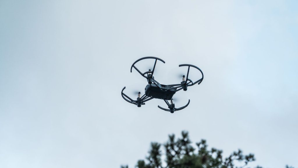 Professional small commercial drone with propeller guards hovering over Gulf Coast Alabama – FAA licensed aerial photography by YellowHammer IT